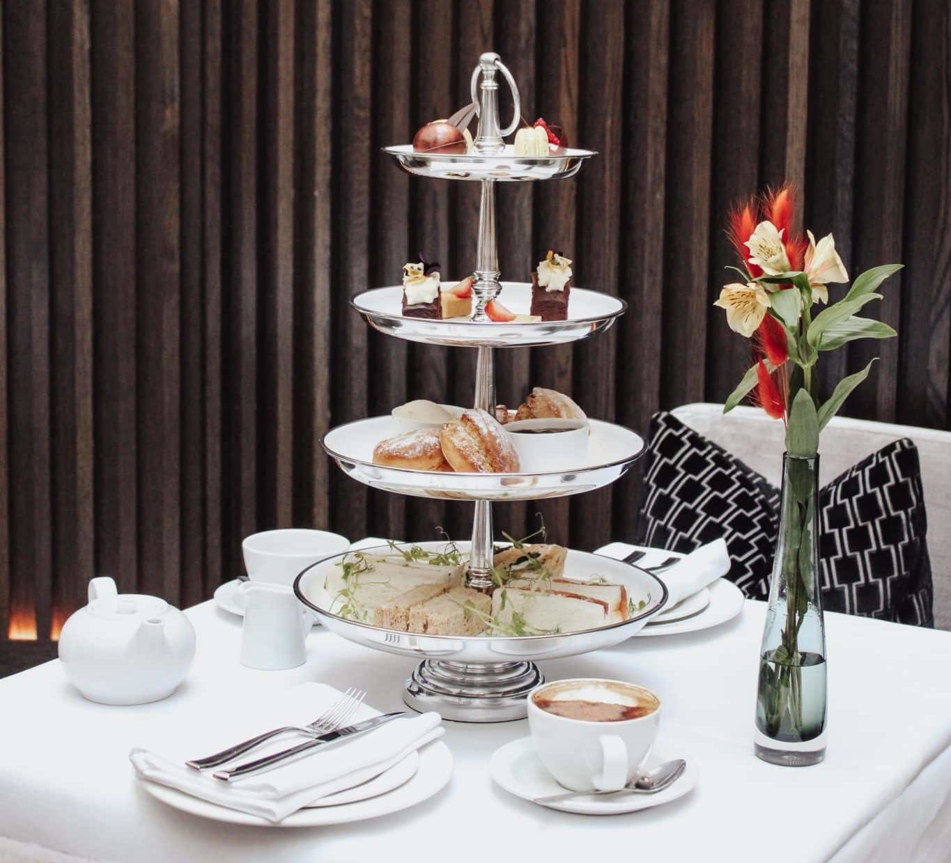 Table set with afternoon tea, snacks and coffee