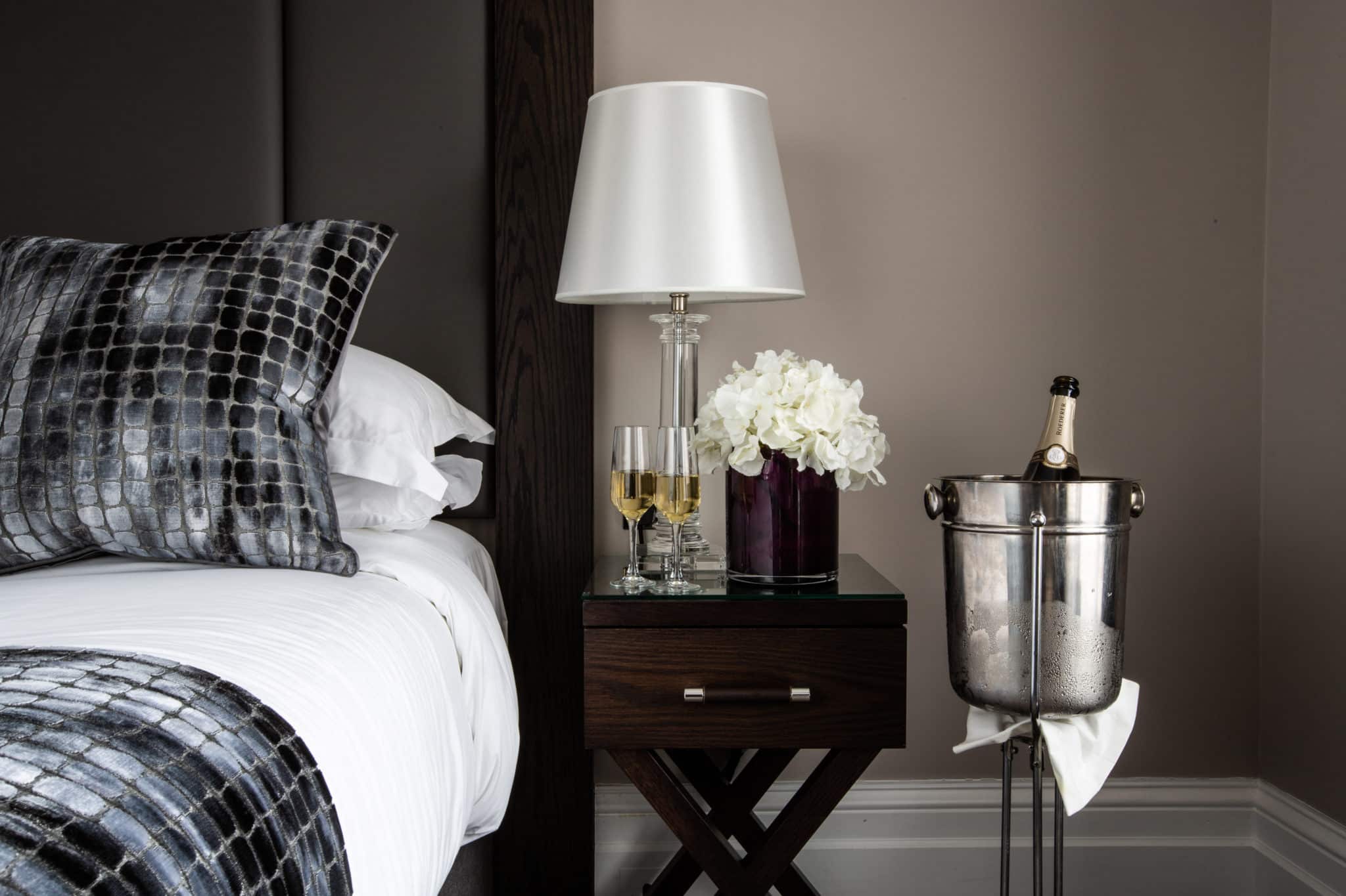 bed and bedside table in a room at one warwick park hotel